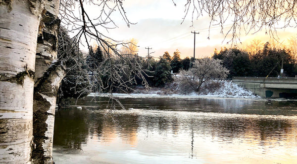 Landscape photo of sunrise after an ice storm alongside river