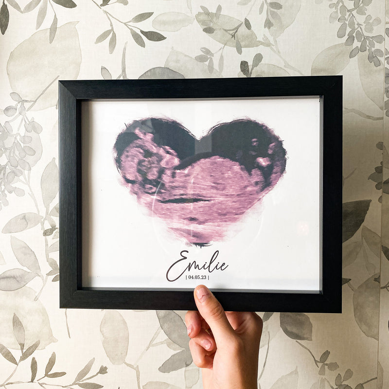 pink heart ultrasound photo in black frame