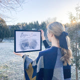 girl holding frame with wedding vow art