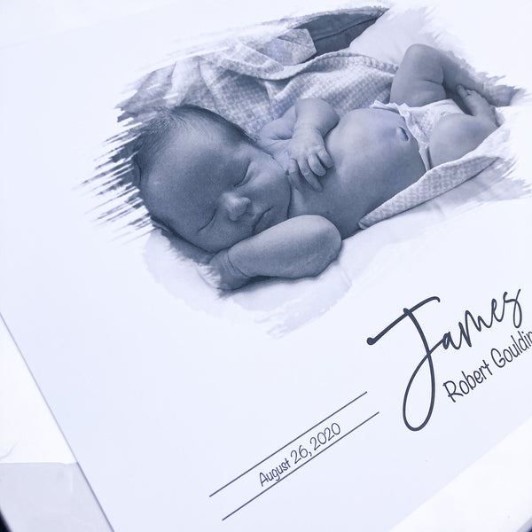 close up look of baby print showing baby photo, name and birthdate
