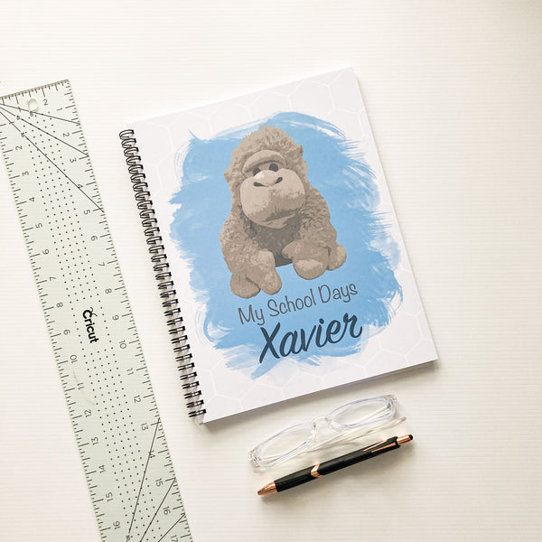 Blue school memory book with gorilla character