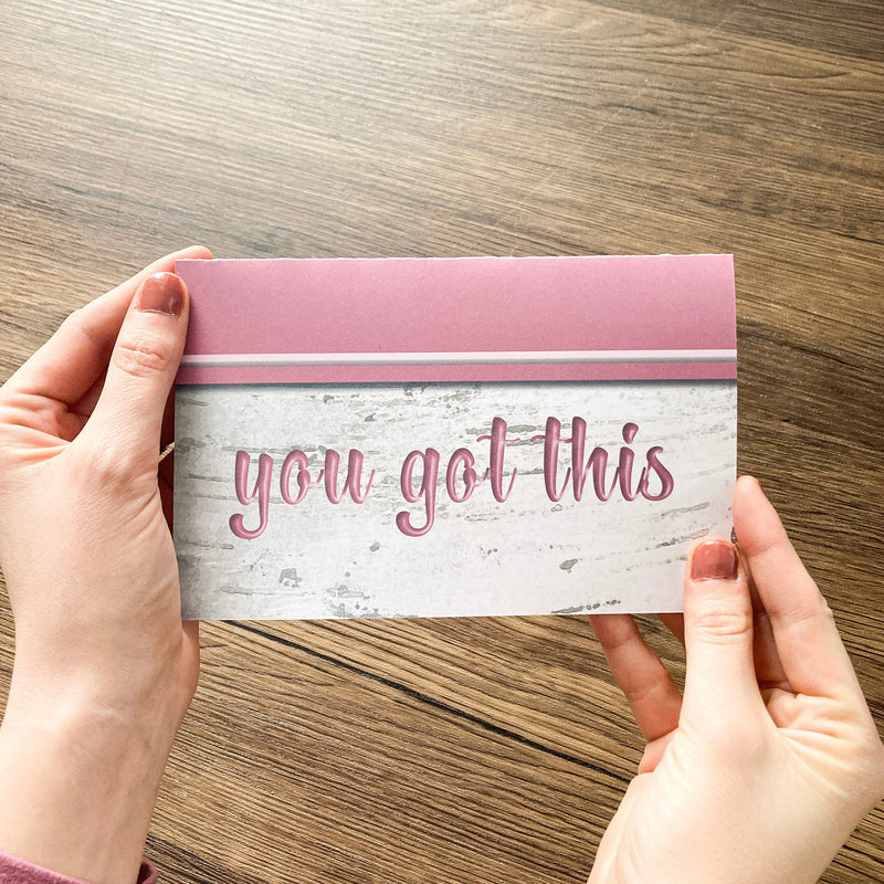 hands holding floral card that says you got this